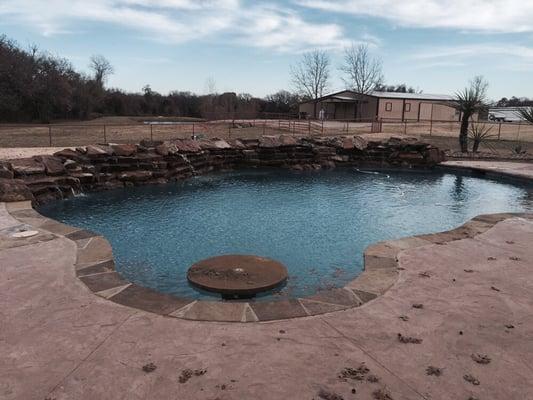 Free form pool with table and waterfall