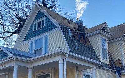 Roofers shingling a steep roof in Salina Kansas