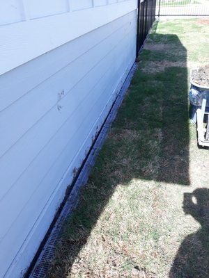 Installing drainage to keep water from flooding the shed.