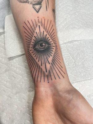 Linework & dotwork style tattoo with the stylized evil eye