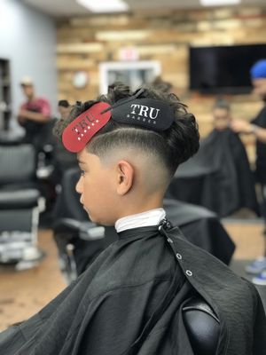 Skin fade with darker corners and  grown the top.