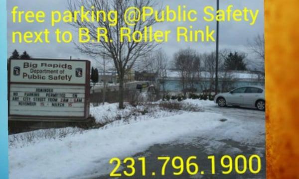 Beloved big ugly blue building in background is Big Rapids Roller Rink.  The free parking is foreground at Public Safety.