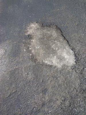 One of many pot holes still not fixed.