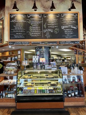 Main counter in center with dessert case, menu above