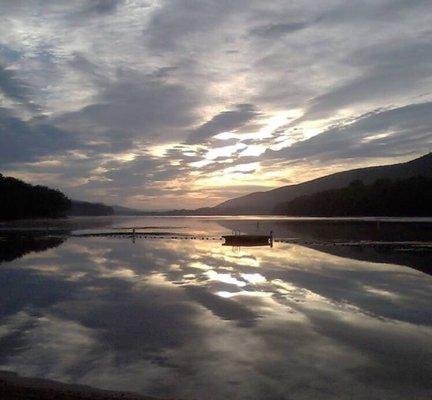 The calm serene lake reflecting the brilliant clouds