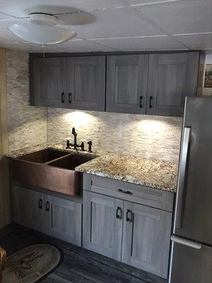 Cabin kitchen with hammered copper farm sink.