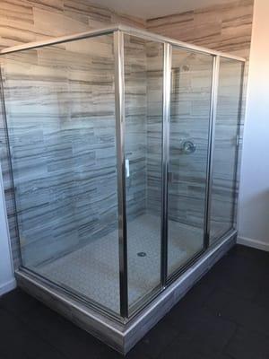 Glass shower enclosure with frame