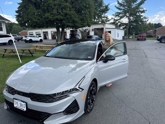 My wife taking delivery of one of the many cars we have purchased from Hart motor company.