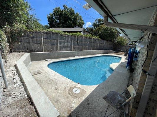 Retaining was with grade for moving water away from the pool deck.