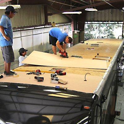 North Trail RV Collision Center technicians replacing an RV roof in Fort Myers, Florida.