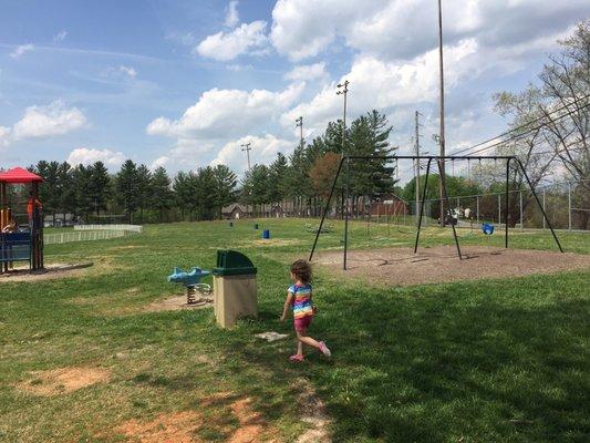 Lots of trash cans and picnic benches