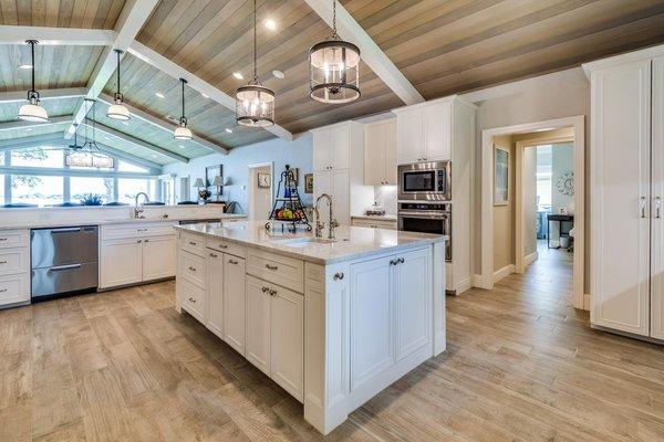 Pendants over both islands and cabinet hardware in this home was supplied by our shop.