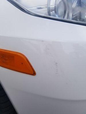 Damage to passenger side front after poor paint job. Guess they thought I wouldn't notice that either