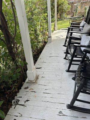 The wraparound porch at the front entrance is very dilapidated