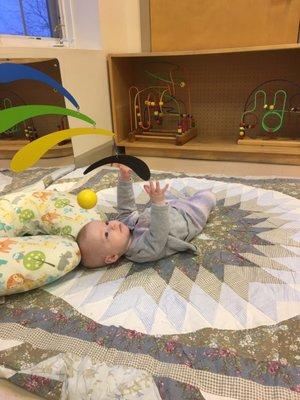 A 5 month old baby working on hand eye coordination!