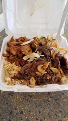 Chicken/steak combo on fried rice and vegetables.