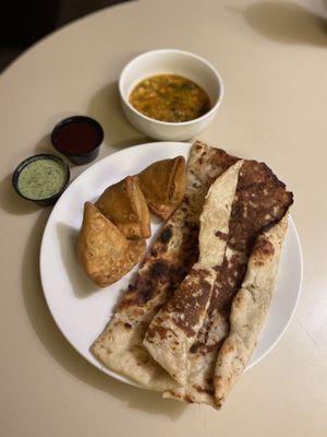 Garlic Naan, 3 Vegetable Samosas, Dal Soup(Bean Soup), Green Chutney (Sauce), Tamarind Sauce.