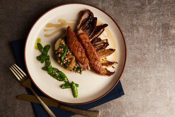 Hudson Valley Duck Breast - Italian Grain Risotto, Cipollini Onions, Sugar Snap Peas, Braised Endive, Rustic Greens, Honey Bourbon Glaze