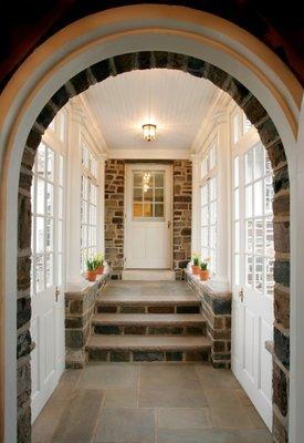 The arch and light-filled breezeway connects the new garage to the historic estate. Lasley Brahaney Architecture + Constructi...