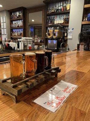 Flight of beer on train track stand