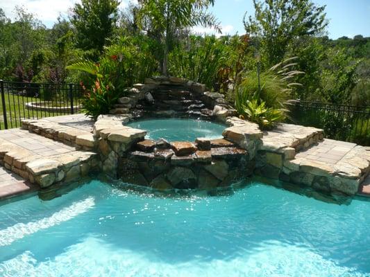 National Pools builds Natural Looking Rock Waterfalls and Rock on Spa and Raised Deck Risers too!