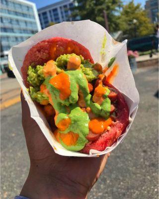 Breakfast arepa with beet dough, sausage, eggs, avocado and all of the sauces!