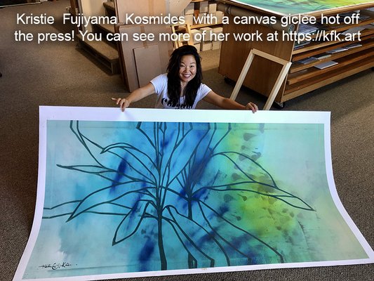 Hilo artist Kristie Fujiyama Kosmides holds up a large canvas print made using our scanning/printing process.