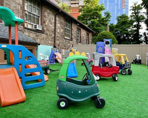 Children choose from a variety of cars and play sets to play with in our playground.