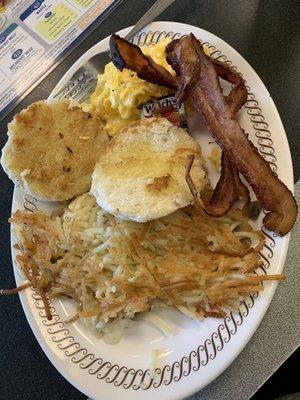 Cheesy scrambled eggs, grilled biscuit, hash browns with onions & mushrooms and bacon. Perfection!