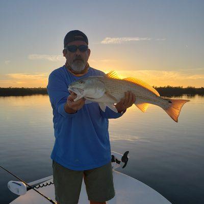 client with redfish in mosquito lagoon