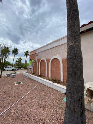 Happy painting worker spraying stucco in Fountain Hills, Arizona.