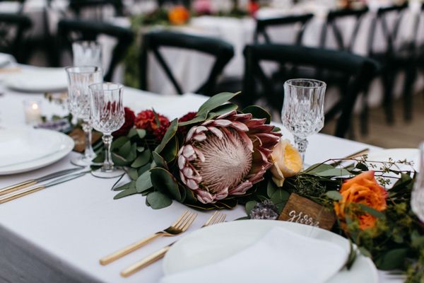 King Protea + eucalyptus draped on the tables