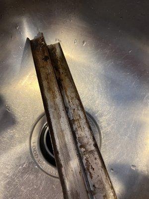 Cutting board track, never cleaned, includes rust..black sludge and stuck on food on the board itself prompted this finding