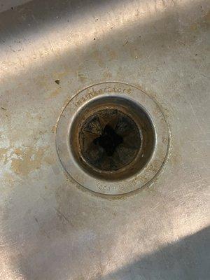 A Kitchen sink , cleaned during a deep cleaning.