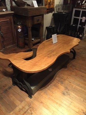 Hand carved whale table with cast iron legs.