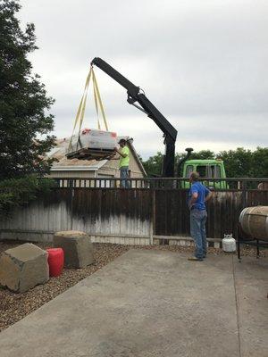 Our crane truck in action delivering a new fireplace to it's happy new owners!