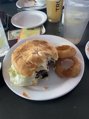 Swiss mushroom burger with onion rings.