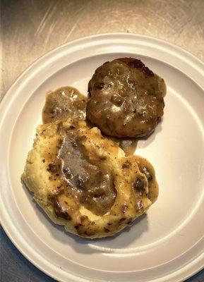 Meatloaf with mashed potatoes and gravy.