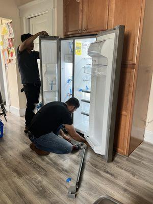 Leveling out the new fridge.