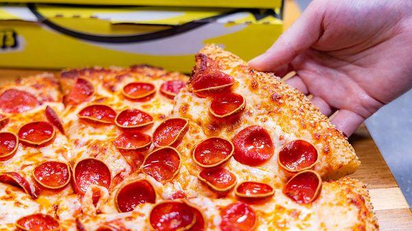 Celebrate 50 Years of Flavor with the '73 Classic, featuring 73 slices of savory pepperoni, gooey cheese, and a crispy crust!