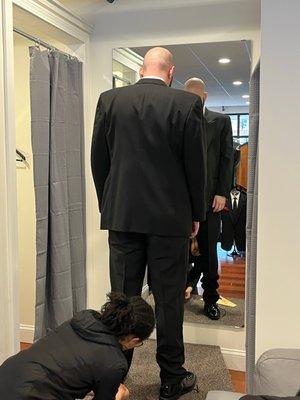 Husband getting fitted and measured for his tux.