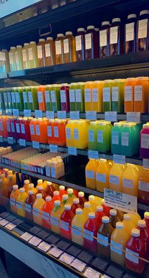 Fresh pressed juice station with juices, infused waters, mixers, and iced teas.