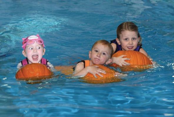 Swimming with pumpkins on Halloween.