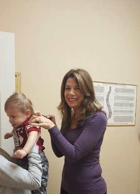 Dr. Julie Syat taking care of toddler patient.