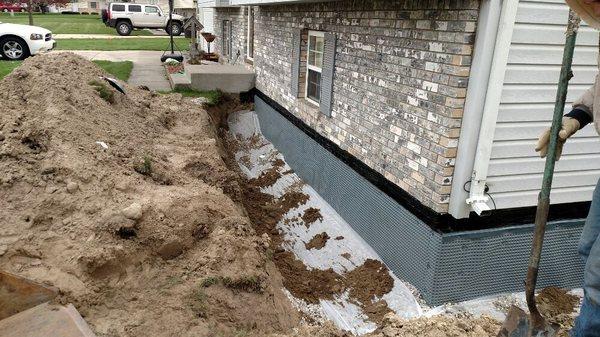 Excavation and waterproofing system installed on existing home.