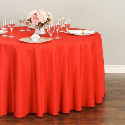 A red 120 inch round polyester tablecloth features a serged hem, seamless design, and durable fabric quality!