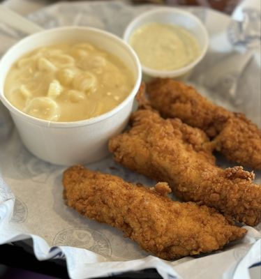 3 chicken strips with the side of mac and cheese and the cilantro crema dipper