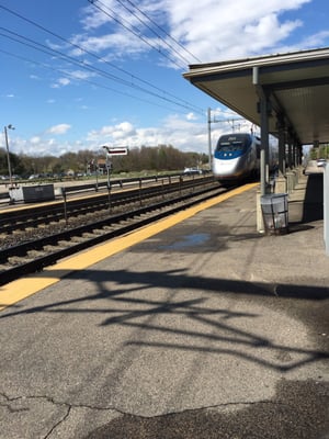 The acela passing by the Mansfield station.