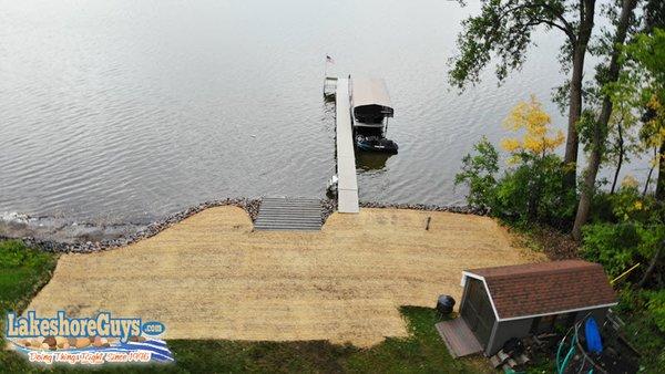 Concrete boat ramp, riprap shoreline, and sand beach - aerial view