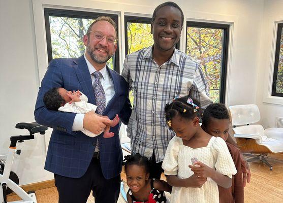 Rabbi Asher Yablok with father and children and newly circumcised baby boy.